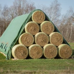 Round Bales in a Pyramid stack under a Toptex sheet